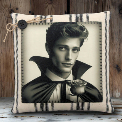 Decorative pillow with a black and white portrait of a handsome young vampire holding a rose on a striped background.