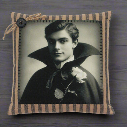 Decorative pillow with a vintage-style portrait of a handsome young vampire in a dark cape on a white background