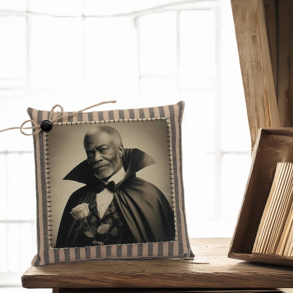 Decorative pillow with a vintage-style portrait of a handsome vampire in a dark robe on a wooden surface.