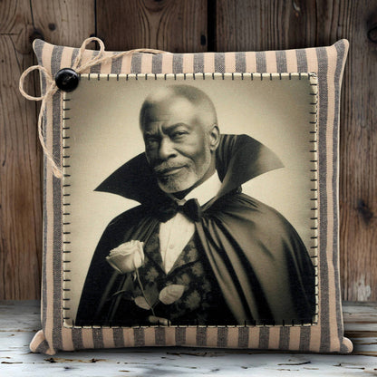Pillow with a vintage-style portrait of a handsome vampire in a cape holding a rose, against a wooden background.