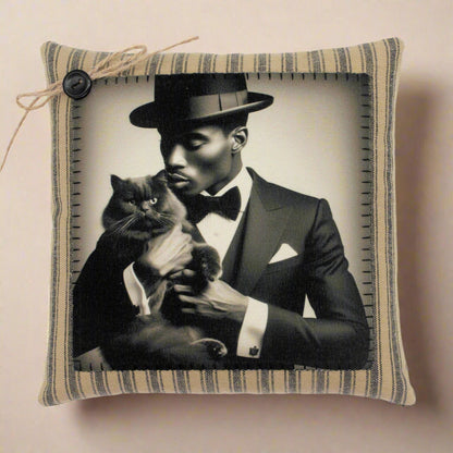 Pillow with a black and white photo of a man in a suit holding a cat, framed by striped fabric.