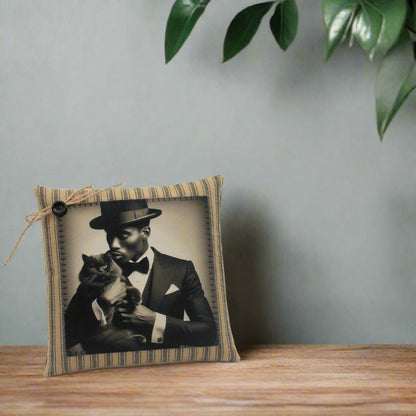 Decorative pillow with a vintage-style photo of a man holding a cat, framed in a striped fabric border.