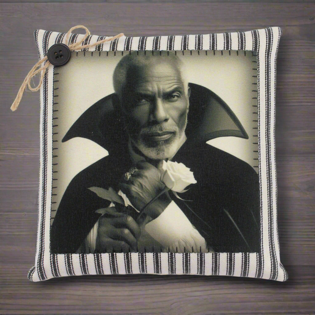Pillow with a black and white portrait of a handsome vampire holding a rose on a striped background