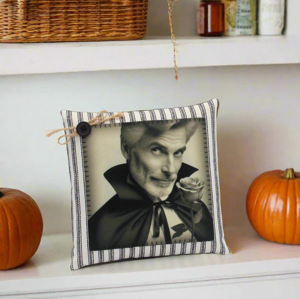 Decorative pillow with a black and white portrait of a handsome vampire holding a rose on a gray background