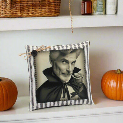 Decorative pillow with a black and white portrait of a handsome vampire holding a rose on a gray background