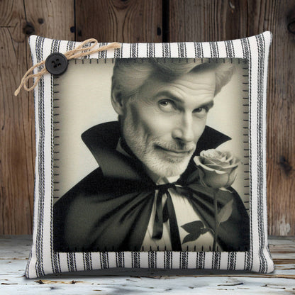 Pillow with a black and white portrait of a handsome vampire holding a rose, framed by a striped border.