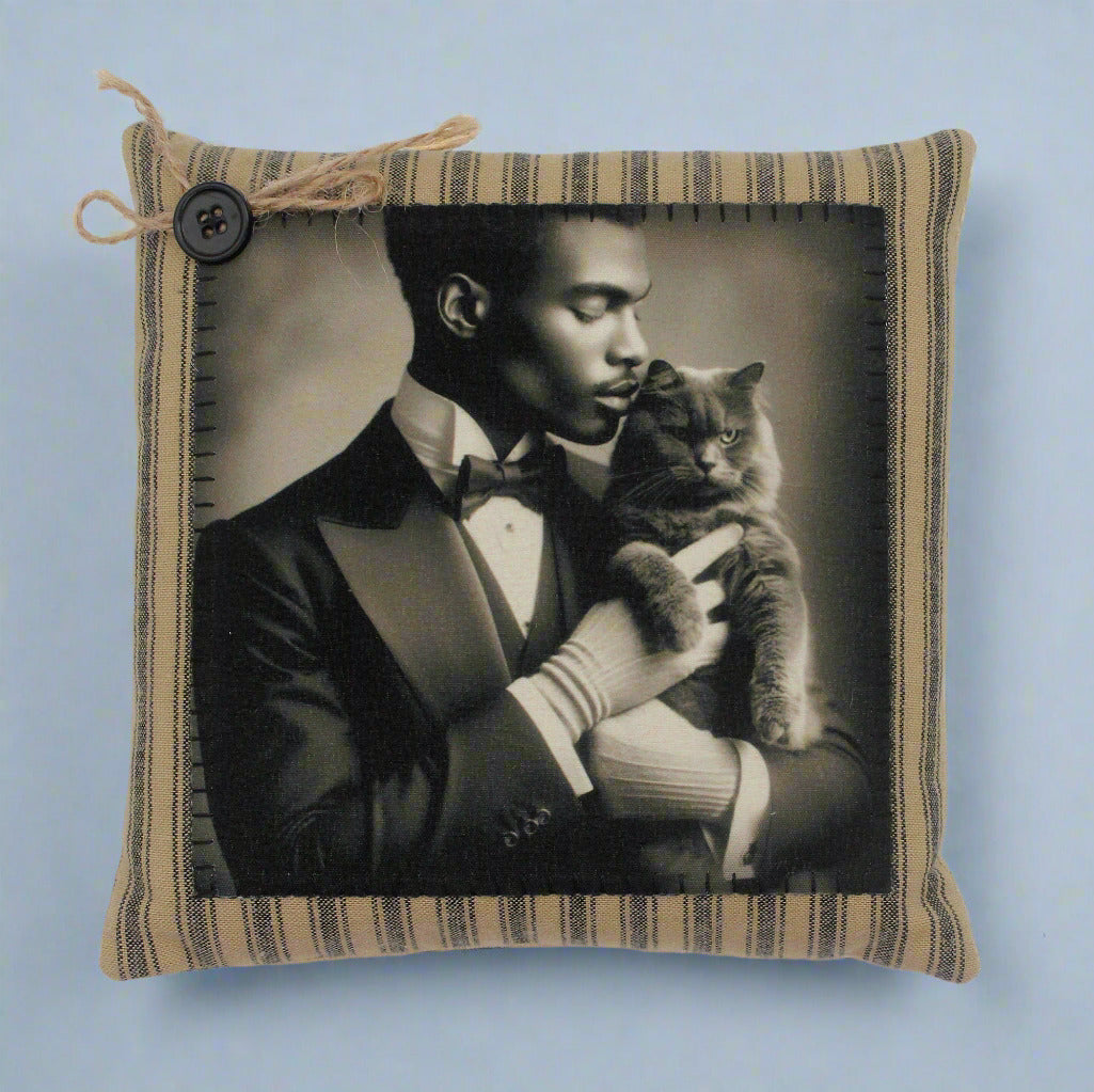 Pillow with a vintage-style photo of a man in a suit holding a cat, framed in a striped fabric border.