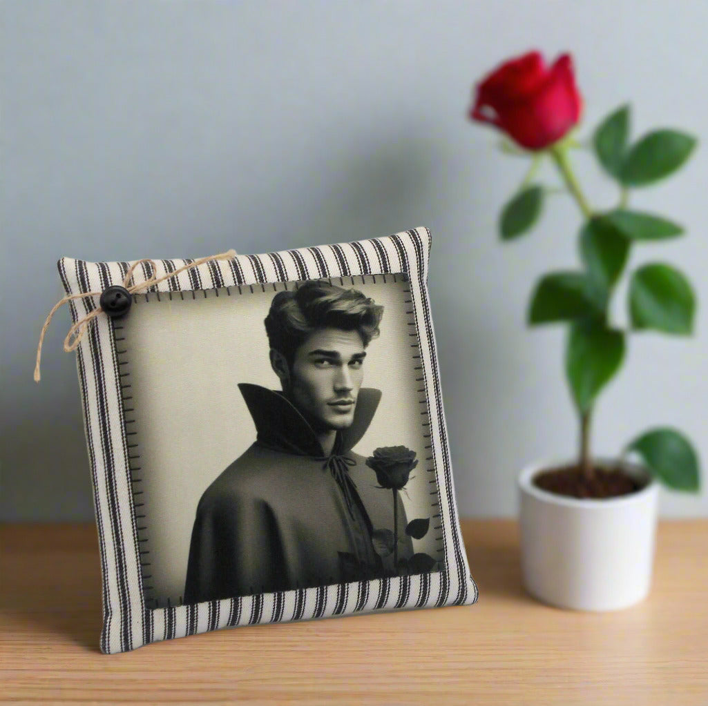 Decorative pillow with a black and white photo of a handsome young vampire holding a rose