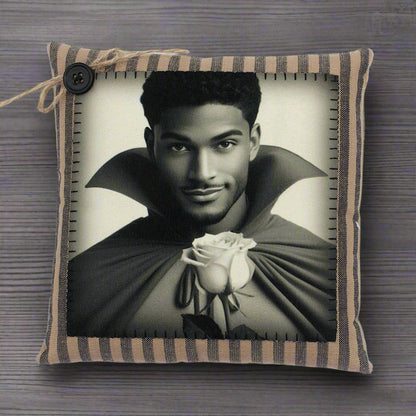 Decorative pillow with a black and white portrait of a handsome young vampire holding a rose on a striped background.