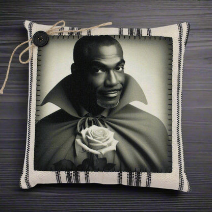 Pillow with a black and white portrait of a handsome vampire holding a rose, framed by decorative fabric.