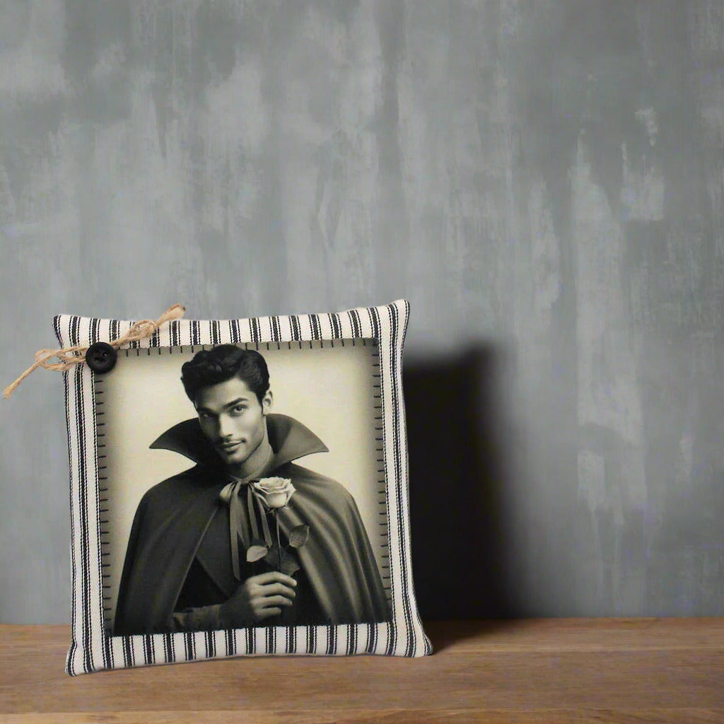 Decorative pillow with a black and white photo of a handsome young vampire holding a rose on a light gray background