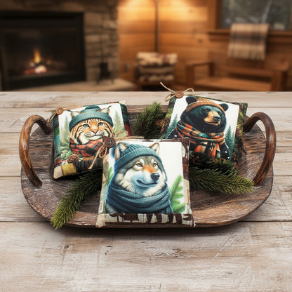 Decorative pillows with animal illustrations wearing hats on a wooden tray.