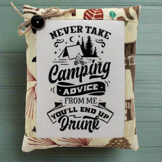 Decorative pillow tuck bowl filler with camping-themed text and graphics on a wooden surface