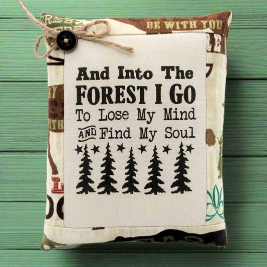Mini pillow bowl filler with text and tree illustrations on a wooden surface