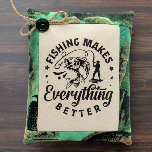 Decorative pillow tuck bowl filler with fishing-themed text and graphics on a wooden surface