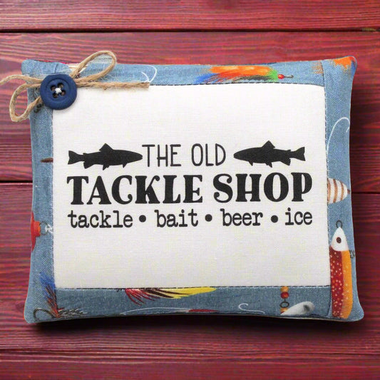 Decorative pillow tuck bowl filler with 'The Old Tackle Shop' text and fishing-themed design on a wooden background