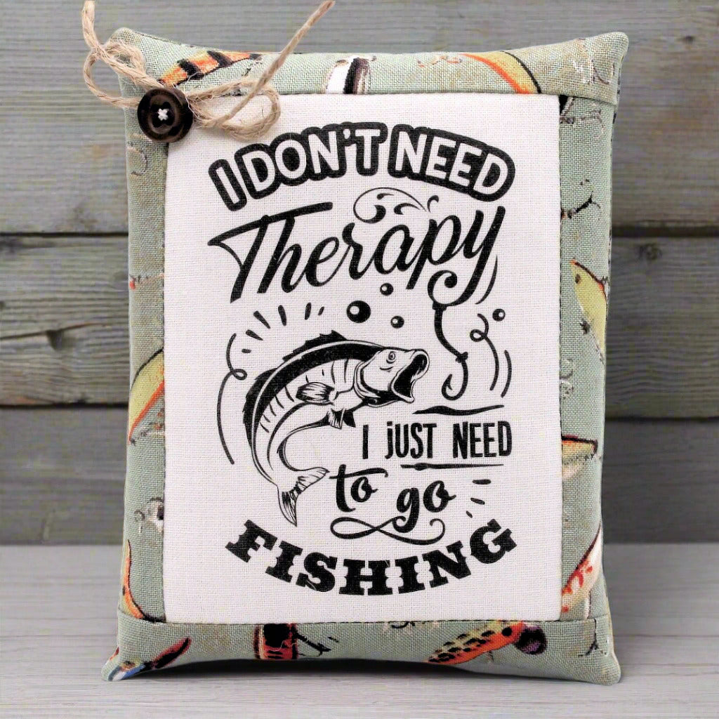 Mini pillow bowl filler with fishing-themed text and graphics on a wooden surface