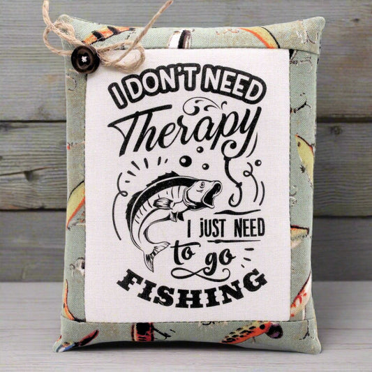 Mini pillow bowl filler with fishing-themed text and graphics on a wooden surface