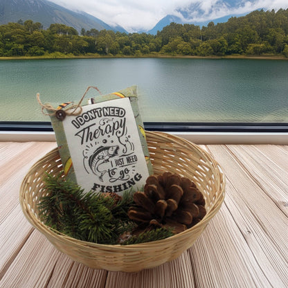 Basket with a sign and fishing lure by a lake