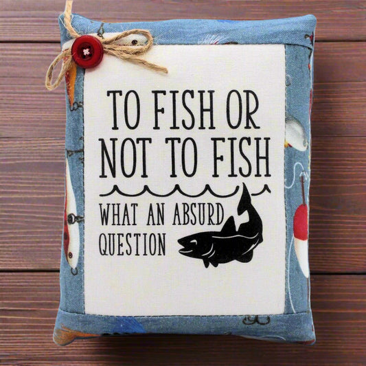 Decorative pillow tuck bowl filler with fishing-themed text and graphics on a wooden surface