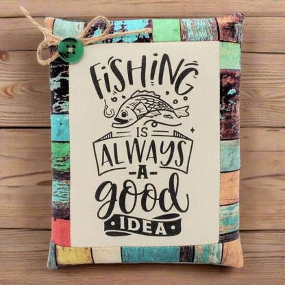 Decorative pillow tuck bowl filler with fishing-themed text and a fish illustration on a wooden surface.
