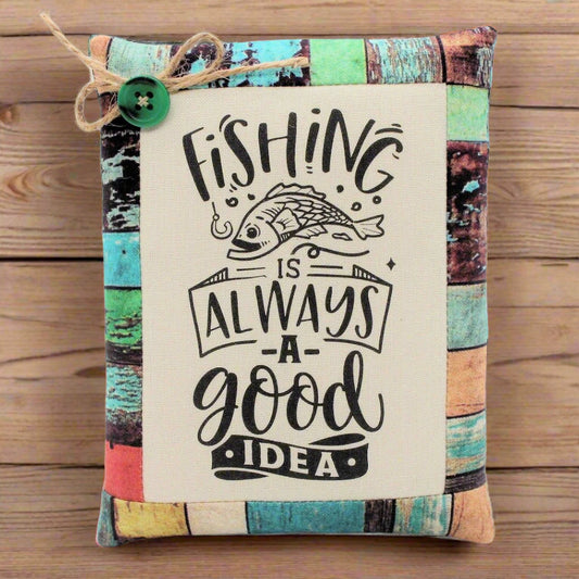 Decorative pillow tuck bowl filler with fishing-themed text and a fish illustration on a wooden surface.