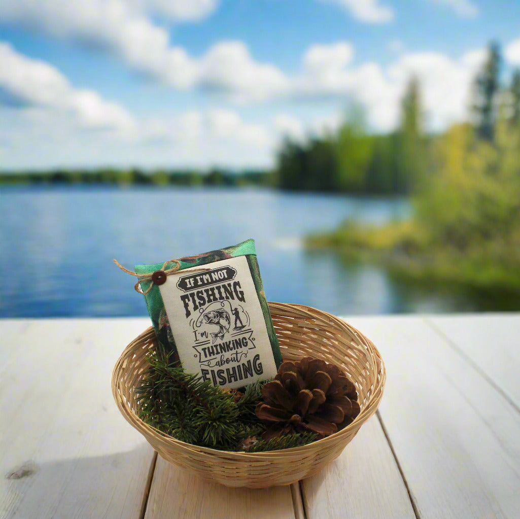 Fishing-themed bowl filler in a woven basket with a scenic lake background