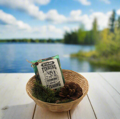 Fishing-themed bowl filler in a woven basket with a scenic lake background