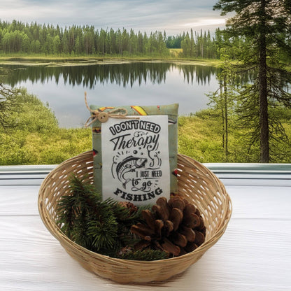 Basket with a sign and fishing-themed items against a scenic lake and forest background
