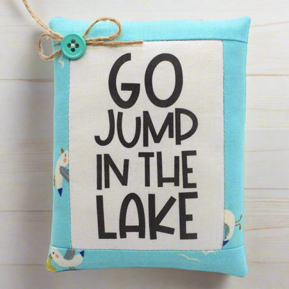 Fabric mini pillow bowl filler with 'GO JUMP IN THE LAKE' text on a light blue border.