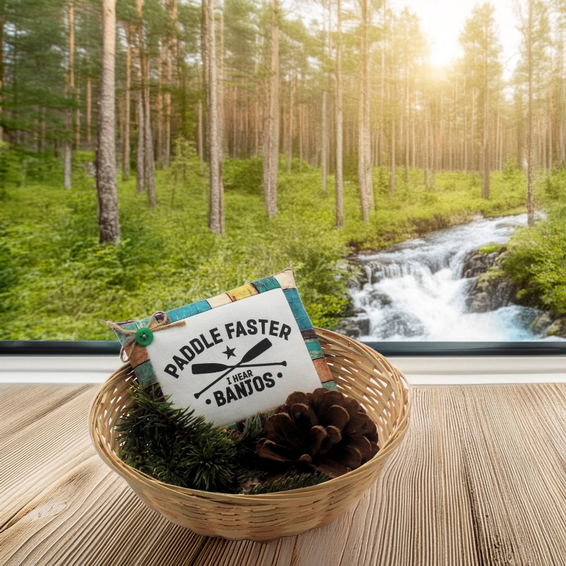 Basket with decorative items on a wooden surface, forest and stream in the background