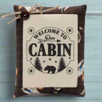 Decorative pillow tuck bowl filler with 'Welcome to Our Cabin' text on a wooden surface