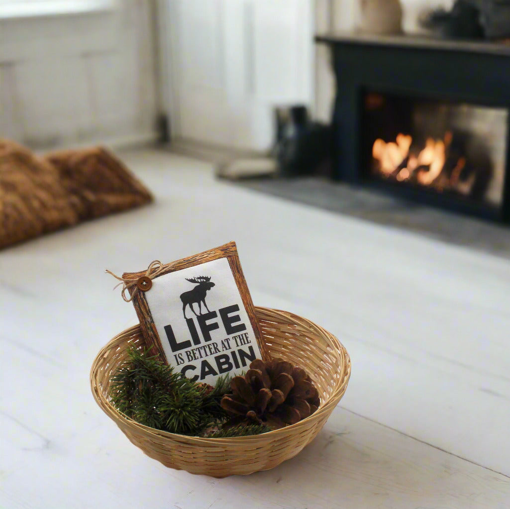 Decorative basket with a sign and pinecones on a white background
