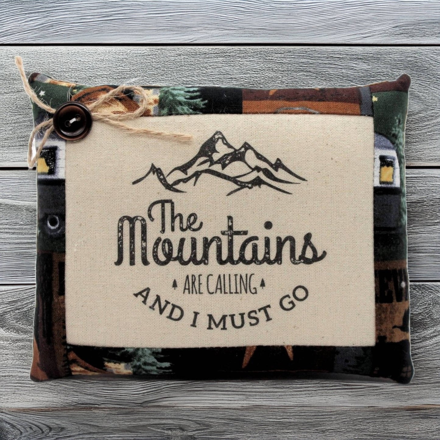 Pillow tuck with 'The Mountains Are Calling' text