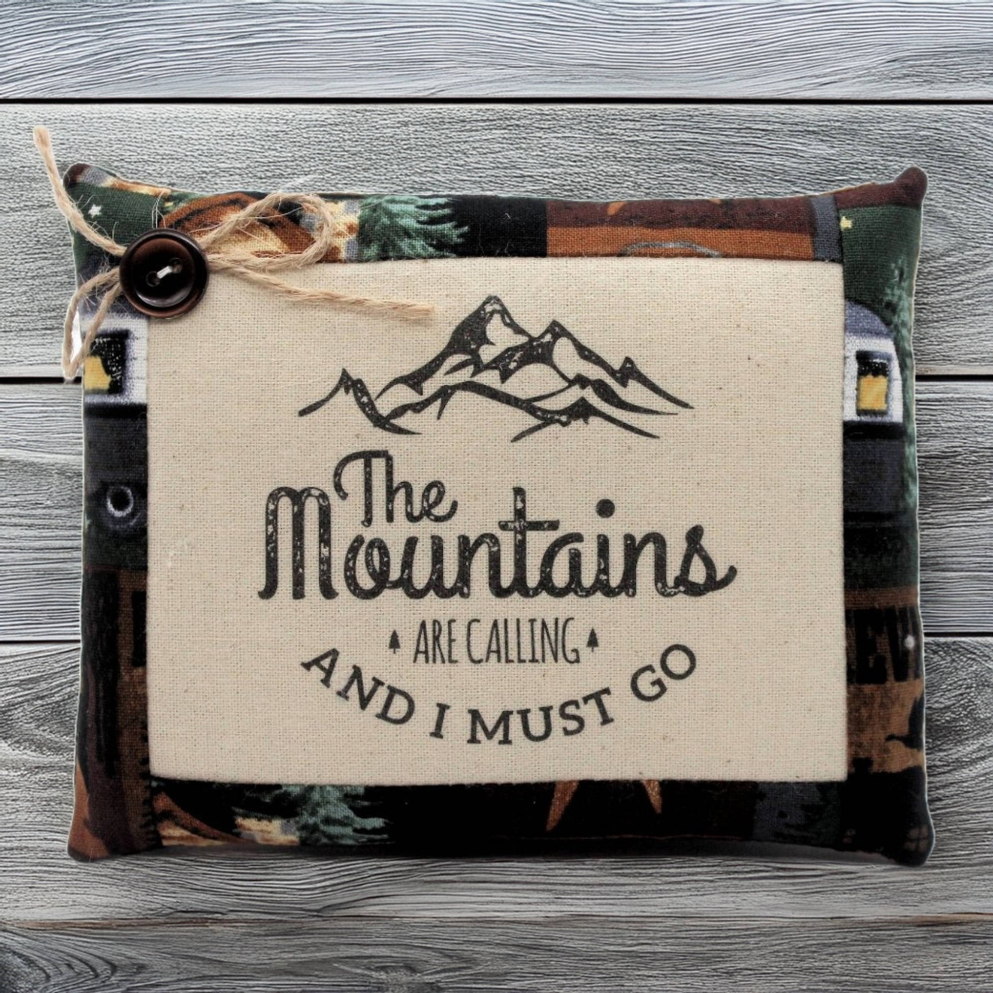 Pillow tuck with 'The Mountains Are Calling' text