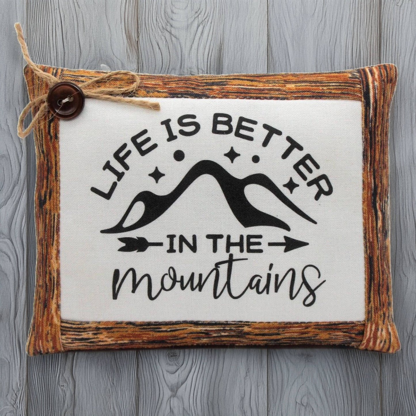 Decorative pillow bowl filler with 'Life is better in the mountains' text on a wooden frame.