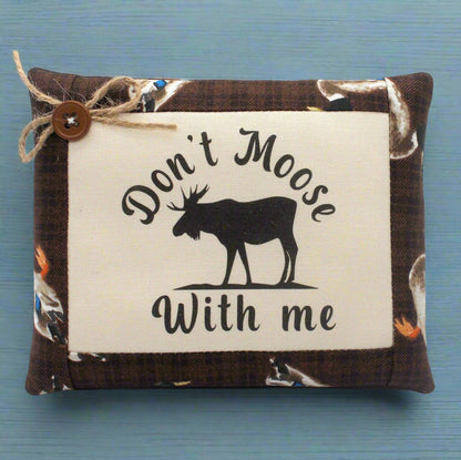 Small pillow tuck with 'Don't Moose With Me' text and moose silhouette on a blue background