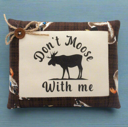 Small pillow tuck with 'Don't Moose With Me' text and moose silhouette on a blue background