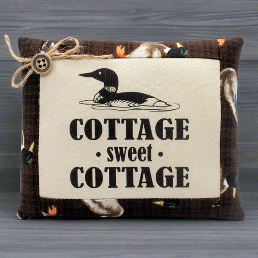 Decorative pillow bowl filler with a duck design and 'Cottage sweet Cottage' text on a wooden background