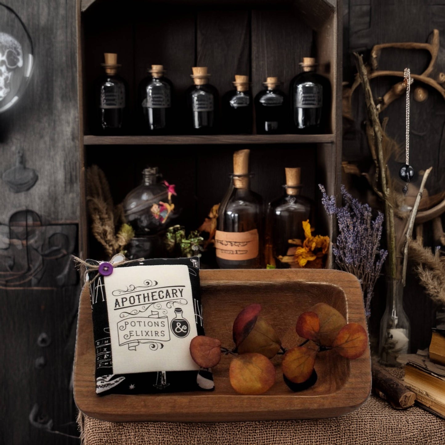Wooden shelf with apothecary bottles and a sign, surrounded by decorative elements.
