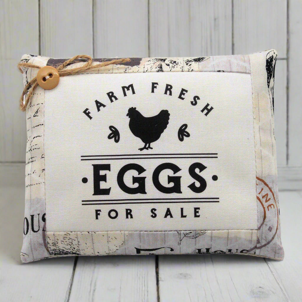 Decorative sign with 'Farm Fresh Eggs For Sale' text and a chicken illustration on a wooden background.