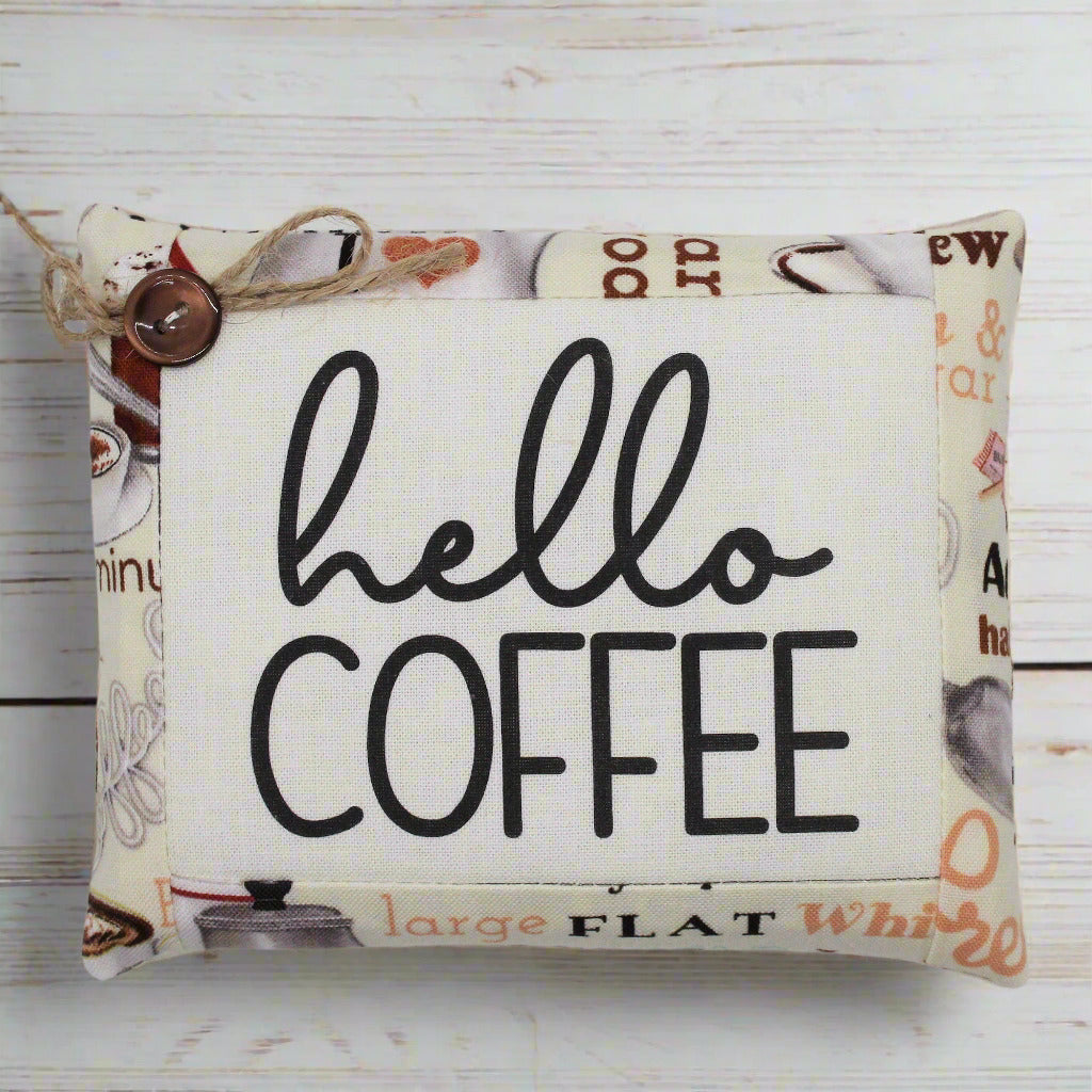 Fabric mini pillow bowl filler sign with 'hello coffee' text on a wooden background