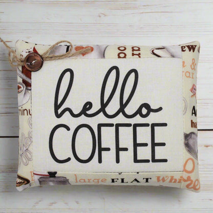 Fabric mini pillow bowl filler sign with 'hello coffee' text on a wooden background