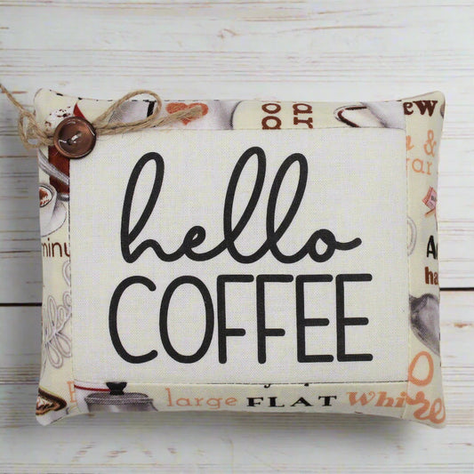 Fabric mini pillow bowl filler sign with 'hello coffee' text on a wooden background