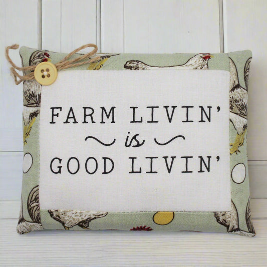 Decorative mini pillow with 'Farm Livin' is Good Livin' text on a white background