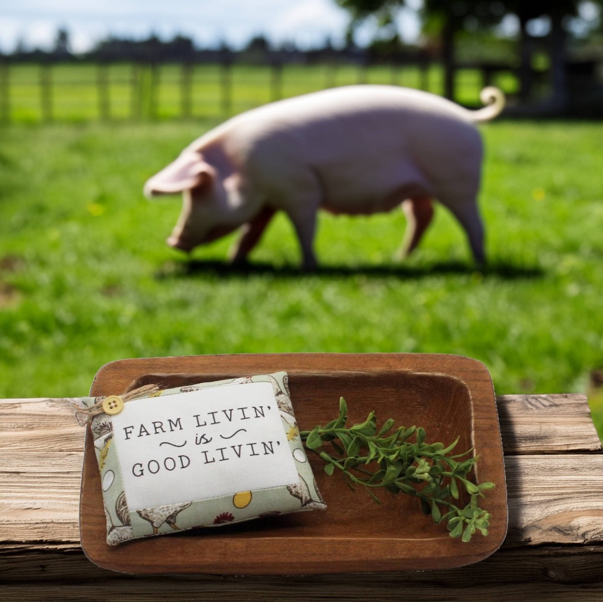 Mini pillow bowl filler sign with 'Farm Livin' is Good Livin' text on a wooden tray with a pig in the background