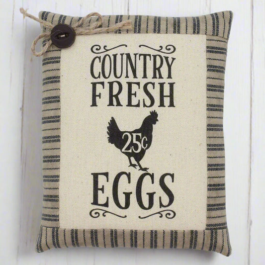Decorative pillow tuck with 'Country Fresh Eggs' text and chicken illustration on a striped background.