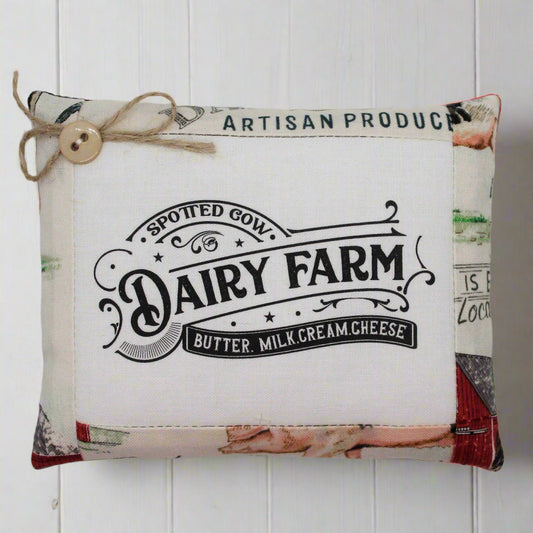 Mini pillow bowl filler sign with 'Dairy Farm' branding on a white wooden background