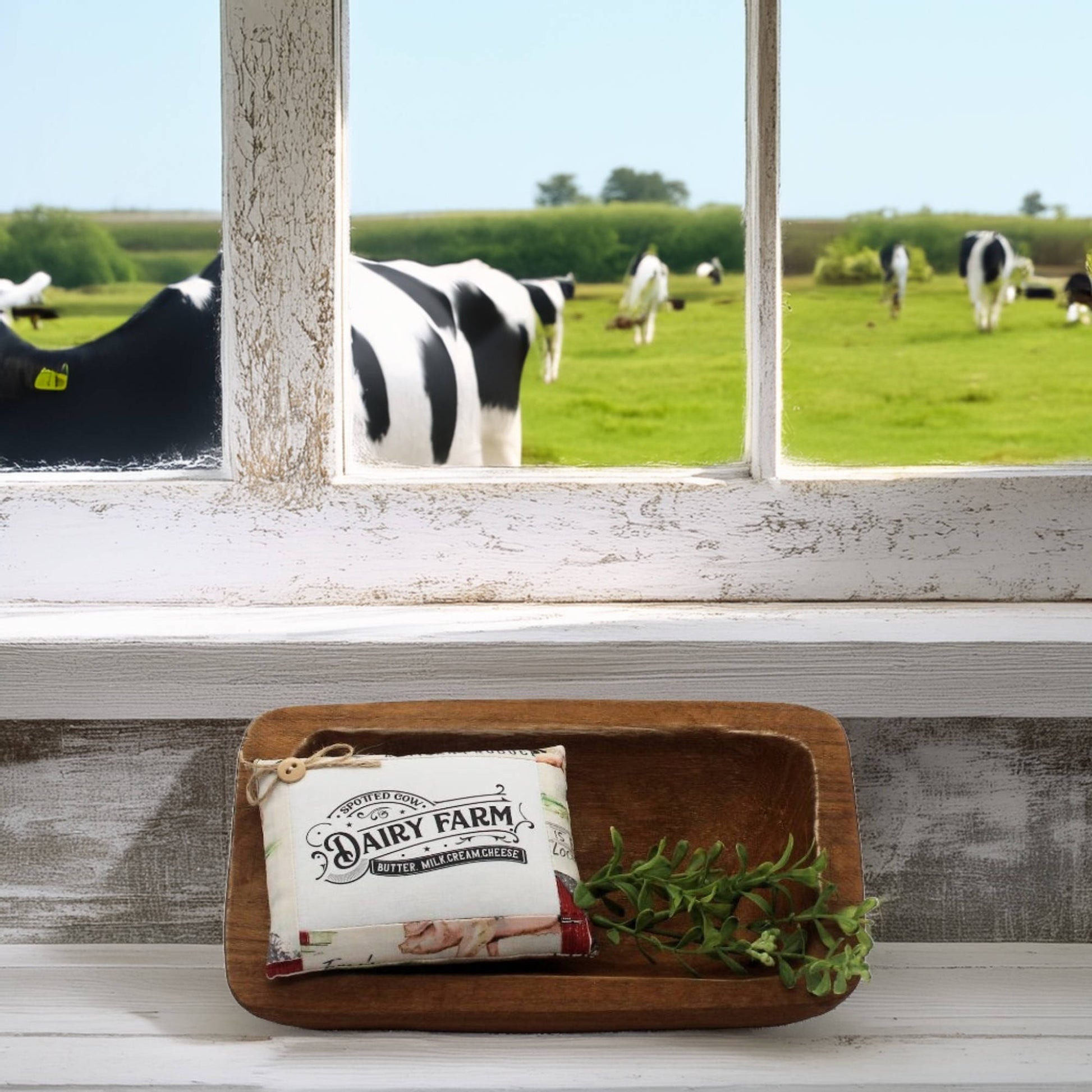 Dairy Farm mini pillow bowl filler sign on a wooden tray with a window view of cows in a field.