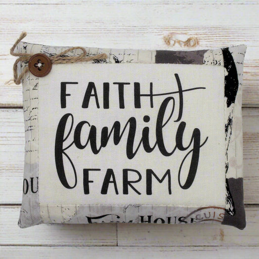 Decorative mini pillow bowl filler with 'Faith Family Farm' text on a wooden background